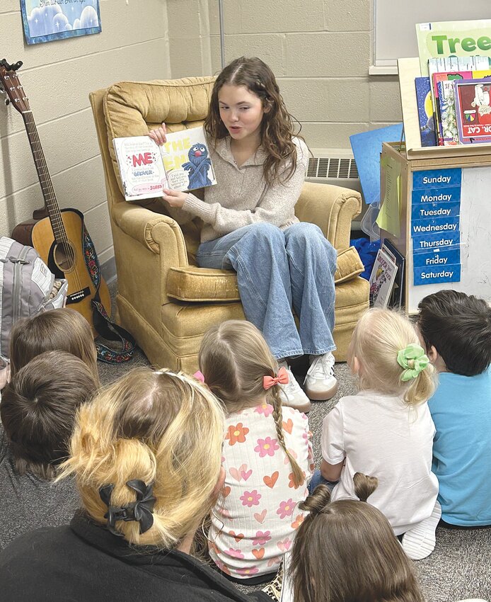Emory Allen was recently a Mystery Reader at Rainbows and Rhymes Preschool at the First United Methodist Church on Wabash Avenue. Each Friday morning a member of the community comes to the preschool to read a story to each preschool class. Allen also treated the students by playing her guitar and singing “You are My Sunshine.” She told the classes that every night when she was a little girl, her mom sang that song when she went to bed.