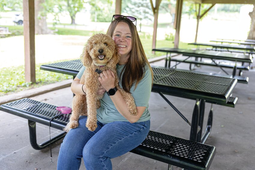 Amanda Richardson holds Lucy, the family’s mini Goldendoodle, after the dog went missing June 7 and was later found 500 miles away in Omaha, Nebraska.