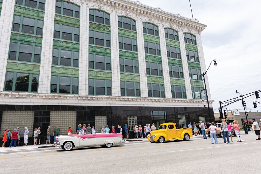 People line up Friday along Water Street ahead of the ribbon-cutting ceremony at the Ben Hur building. Hundreds gathered to hear remarks from the developer and Crawfordsville Mayor Todd Barton before touring the five-story building at the corner of East Main and Water streets.