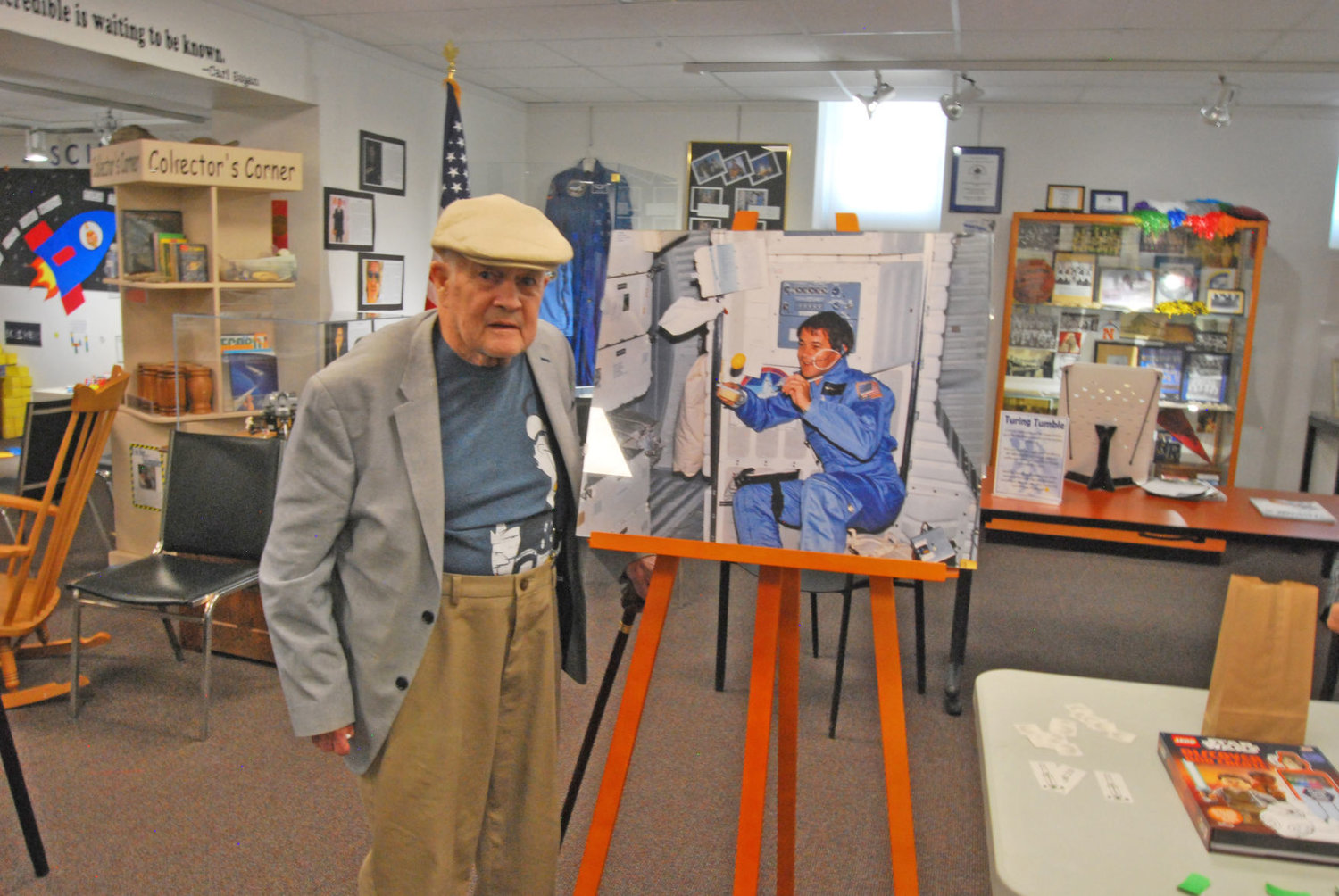 Retired astronaut Joe Allen stands next to a photo of himself from a 1980s space shuttle flight at the Carnegie Museum of Montgomery County. Allen visited the museum to help celebrate the 50th anniversary of the moon landing.
