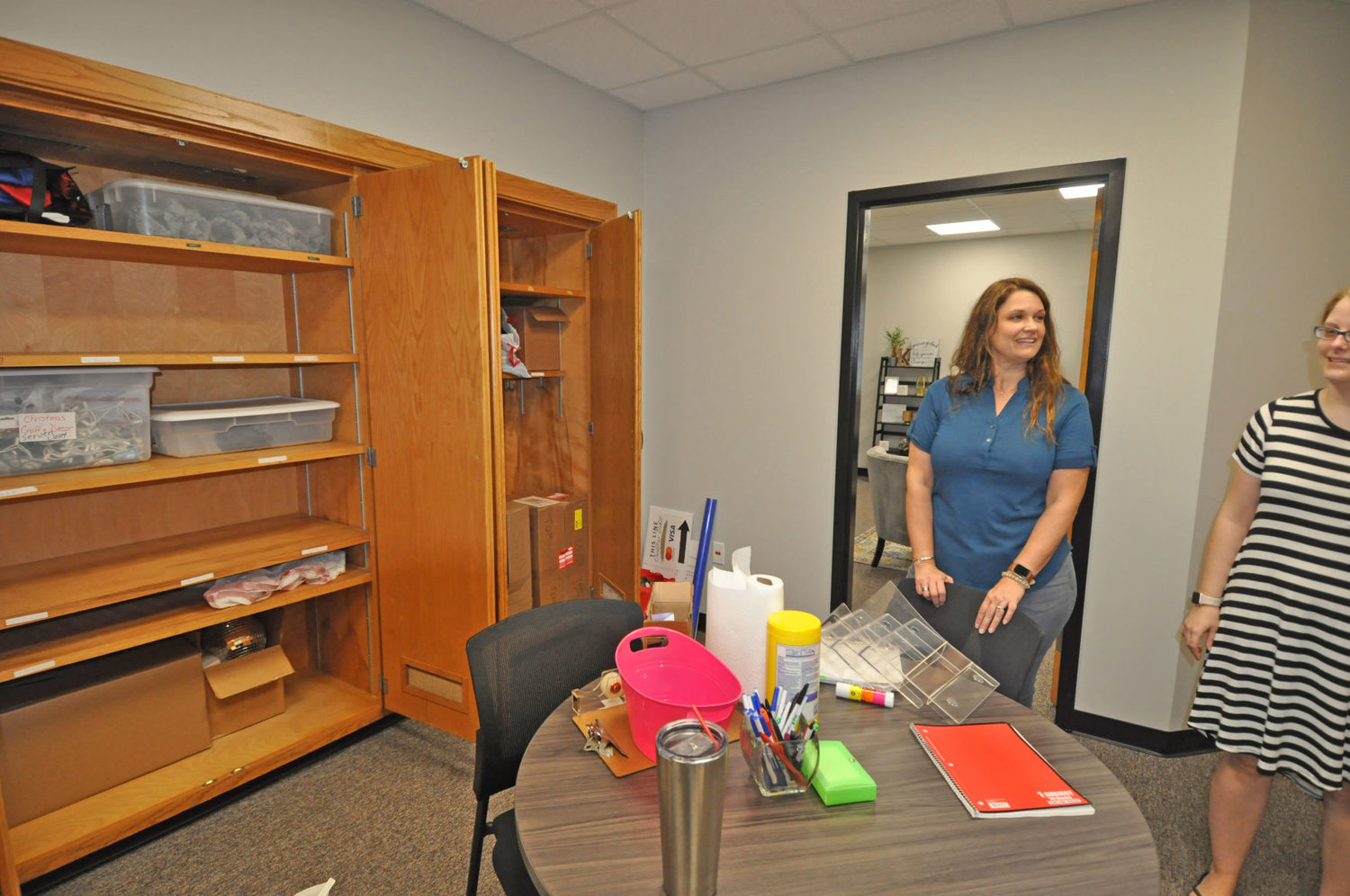 Kate Doty, left, and Sara Clapp finish unpacking as the new Montgomery County Youth Service Bureau offices at what used to be the Caleb Mills School on West Pike Street. Monday was the first official day in the newly renovated building.