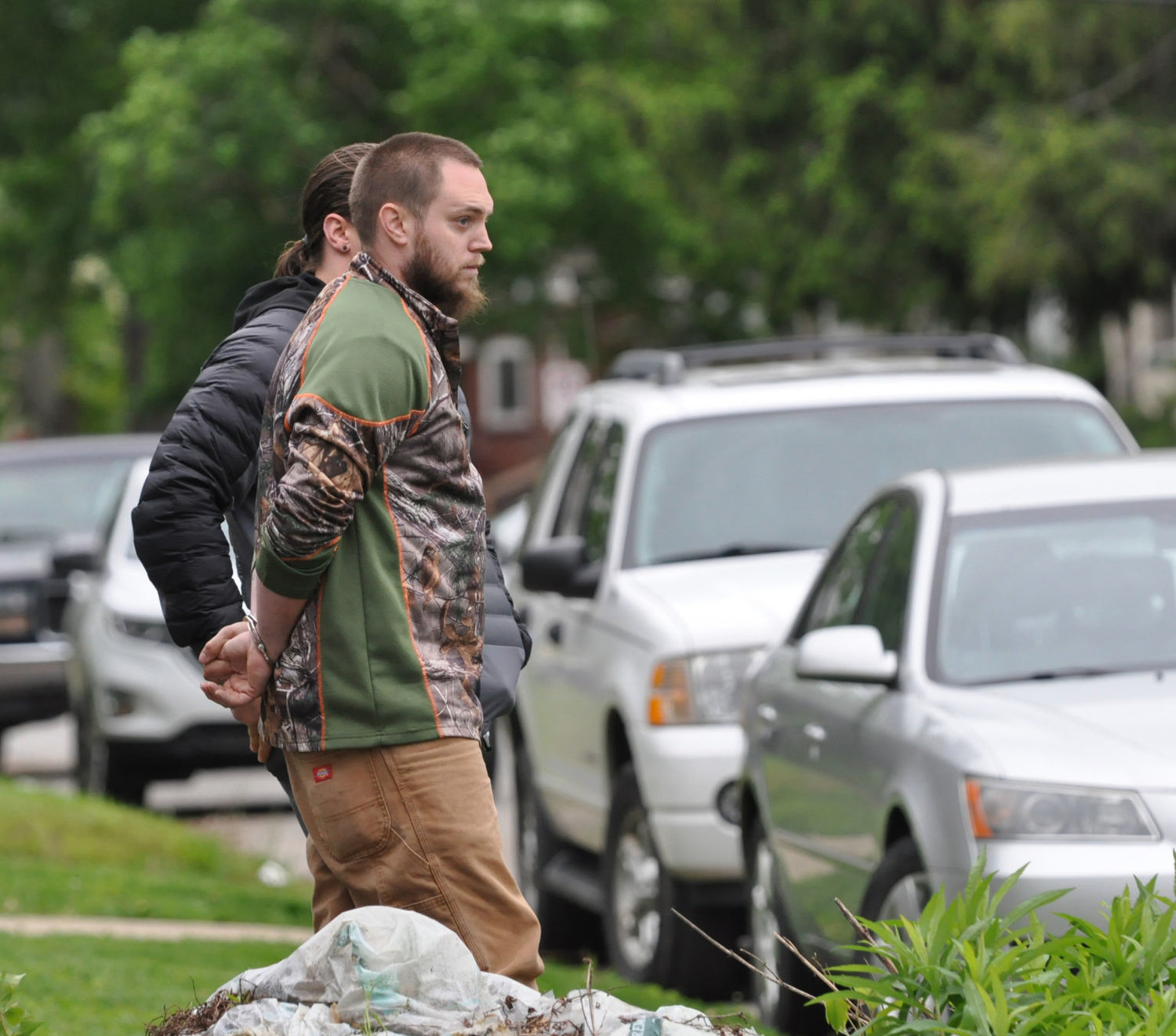 William (Billy) A. Perkins, 28, watches as officers from the Indiana State Police search his Crawfordsville home Tuesday.