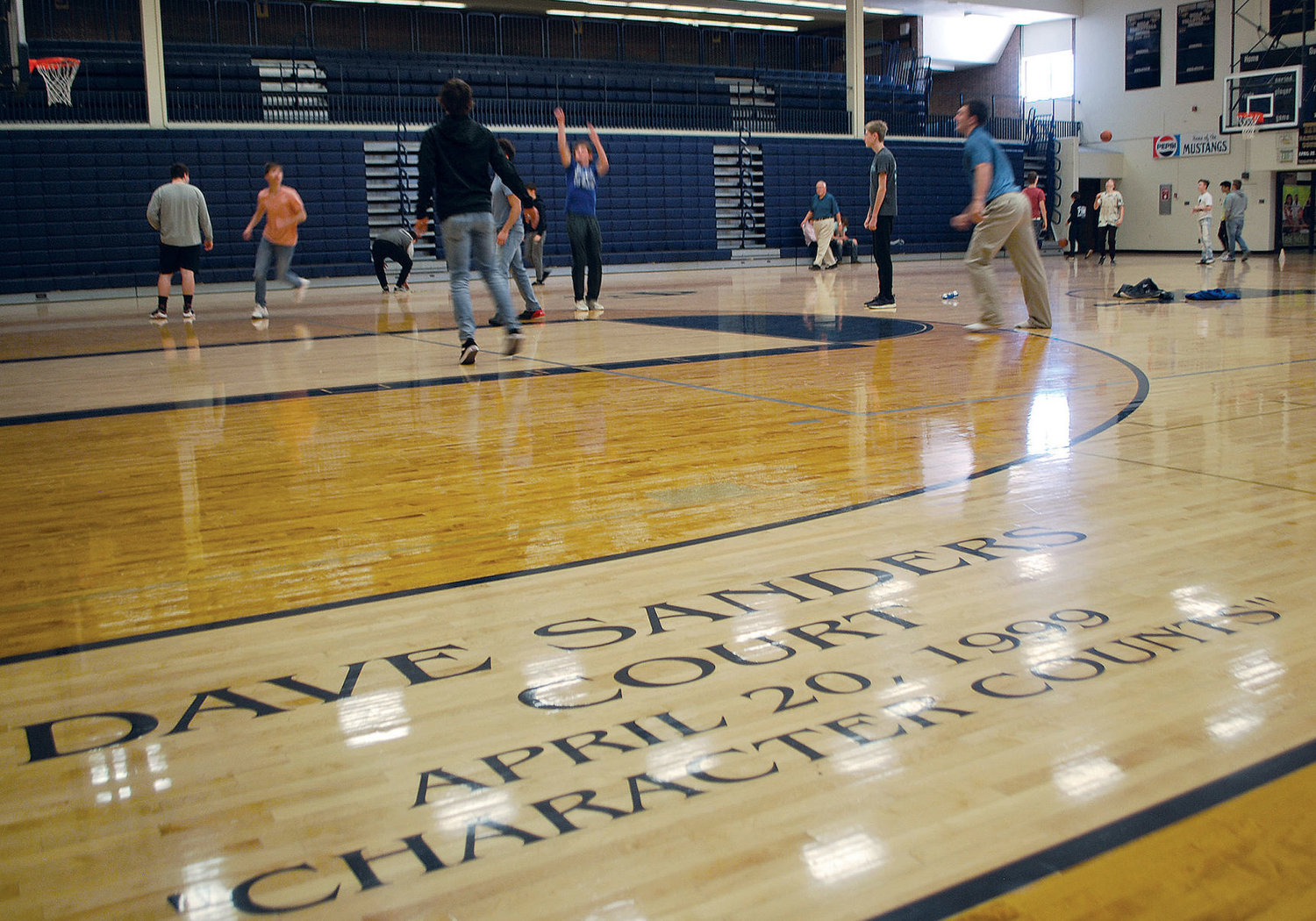 Students play basketball on Dave Sanders Court at Fountain Central High School. Sanders, a 1969 graduate, was the teacher killed in the Columbine High School massacre 20 years ago.