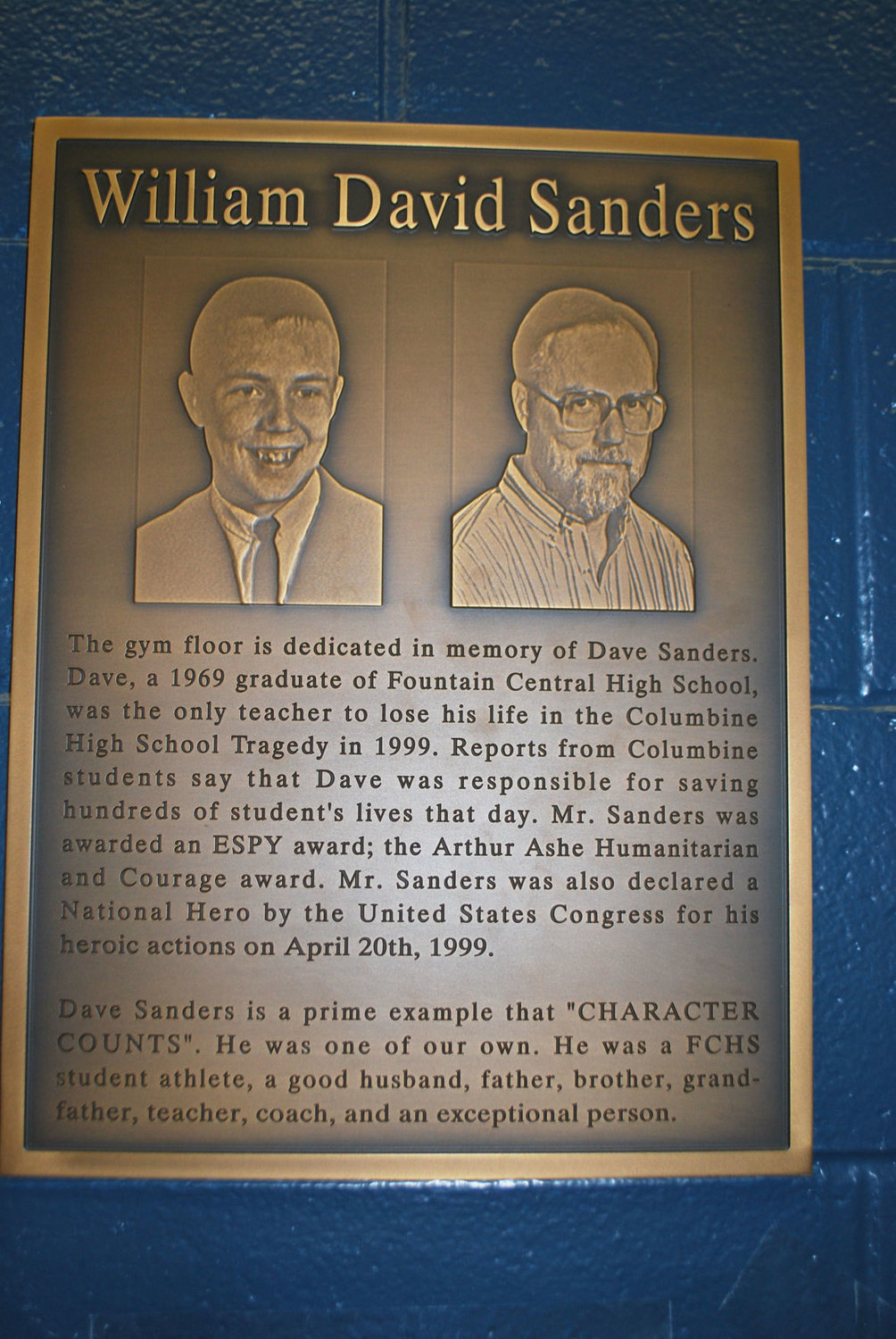 A plaque recognizing Dave Sanders hangs outside the gym of Fountain Central High School, where Sanders graduated in 1969.