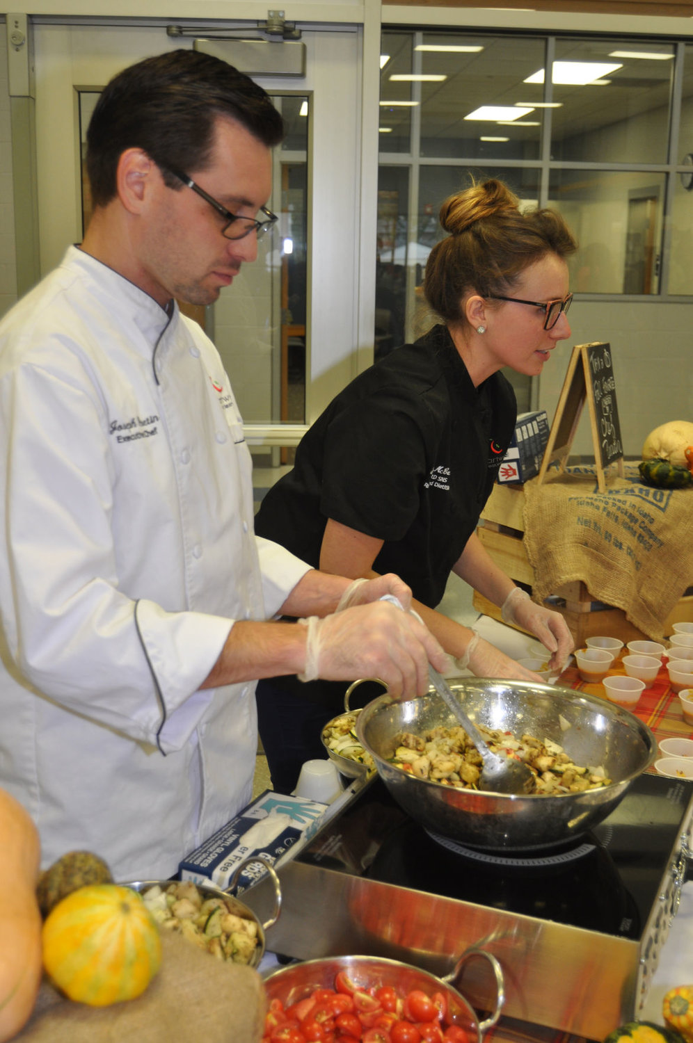 Chartwells chef Joseph Peretin stirs Ratatouille as resident dietician Tarrah McCreary speaks to students Friday during the Farm to School event at Crawfordsville Middle School.