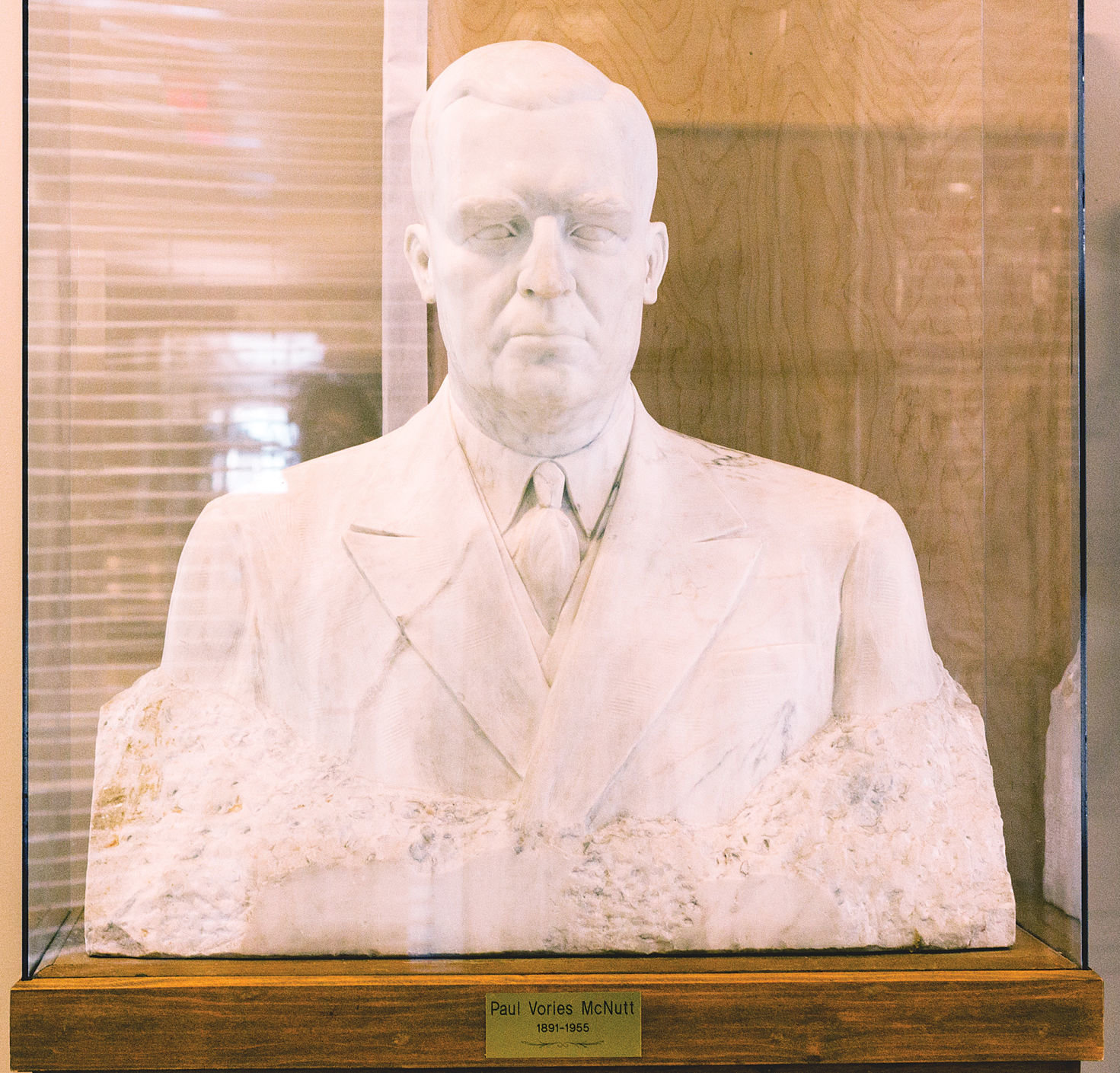 The Indiana University campus in Bloomington displays two sculptures of Paul V. McNutt: a bronze head-and-shoulders bust in the Memorial Union between the two doors to Alumni Hall and this marble one in the McNutt Residence Center.