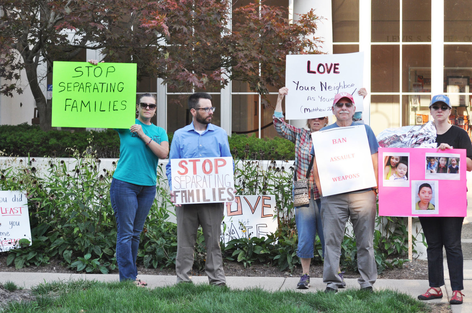 Members of Humans United for Equality protest the Trump administration's immigration policies and call for stronger gun control Tuesday before Sen. Mike Braun's appearance at Wabash College. The protesters were part of a group of about 10 people calling for Braun to oppose Trump's southern border policies.