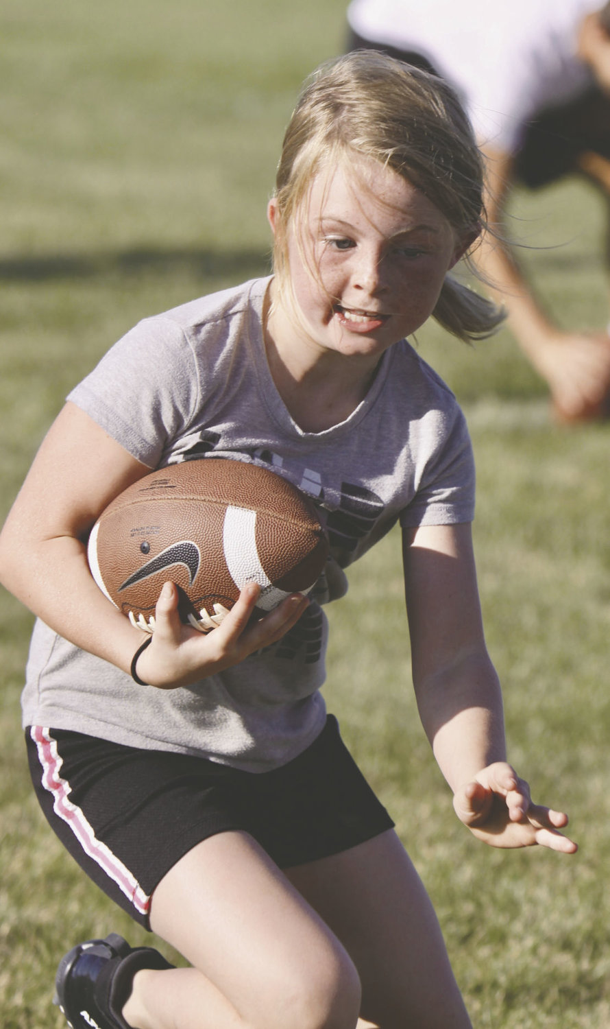 Ava Kincade was showing off her power as she catches the ball during the Charger football camp.