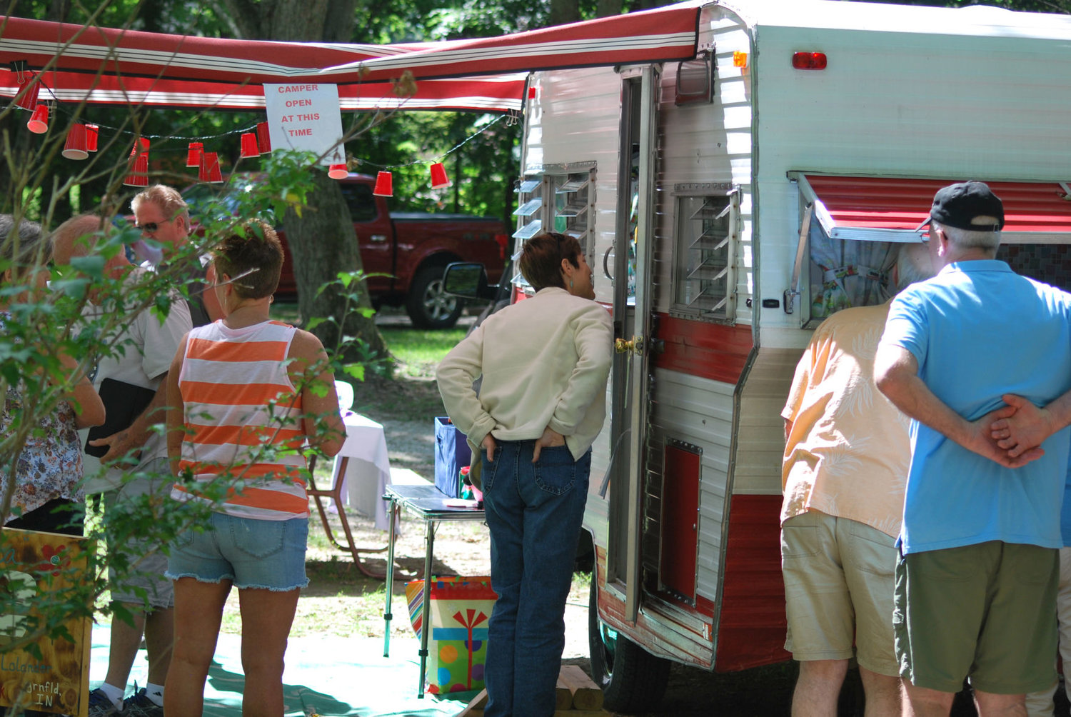 People look inside a vintage trailer owned by Kevin and Brenda Burk of Greenfield Saturday at an open house for the Mid-Central Indiana Vintage Camper Rally at KOA Campgrounds. The rally featured retro trailers decorated in a paradise theme.