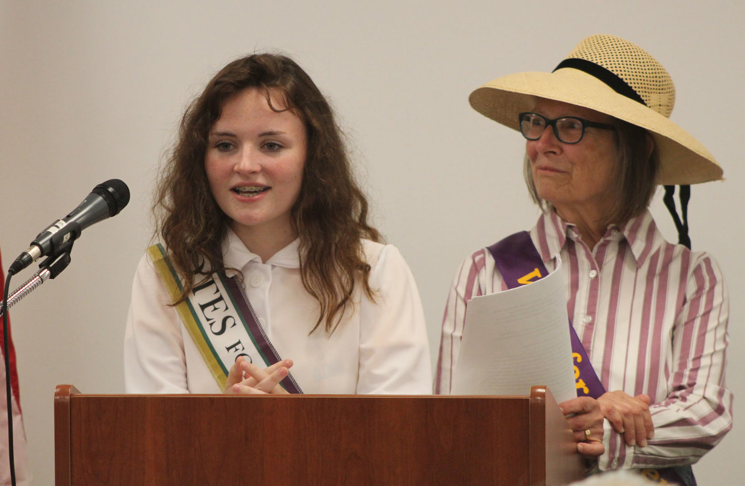 North Montgomery High School student Mae Dees speaks during the kickoff celebration for the women's suffrage centennial as Helen Hudson looks on Monday at the Crawfordsville District Public Library. Dees has been working to get classmates involved with the League.
