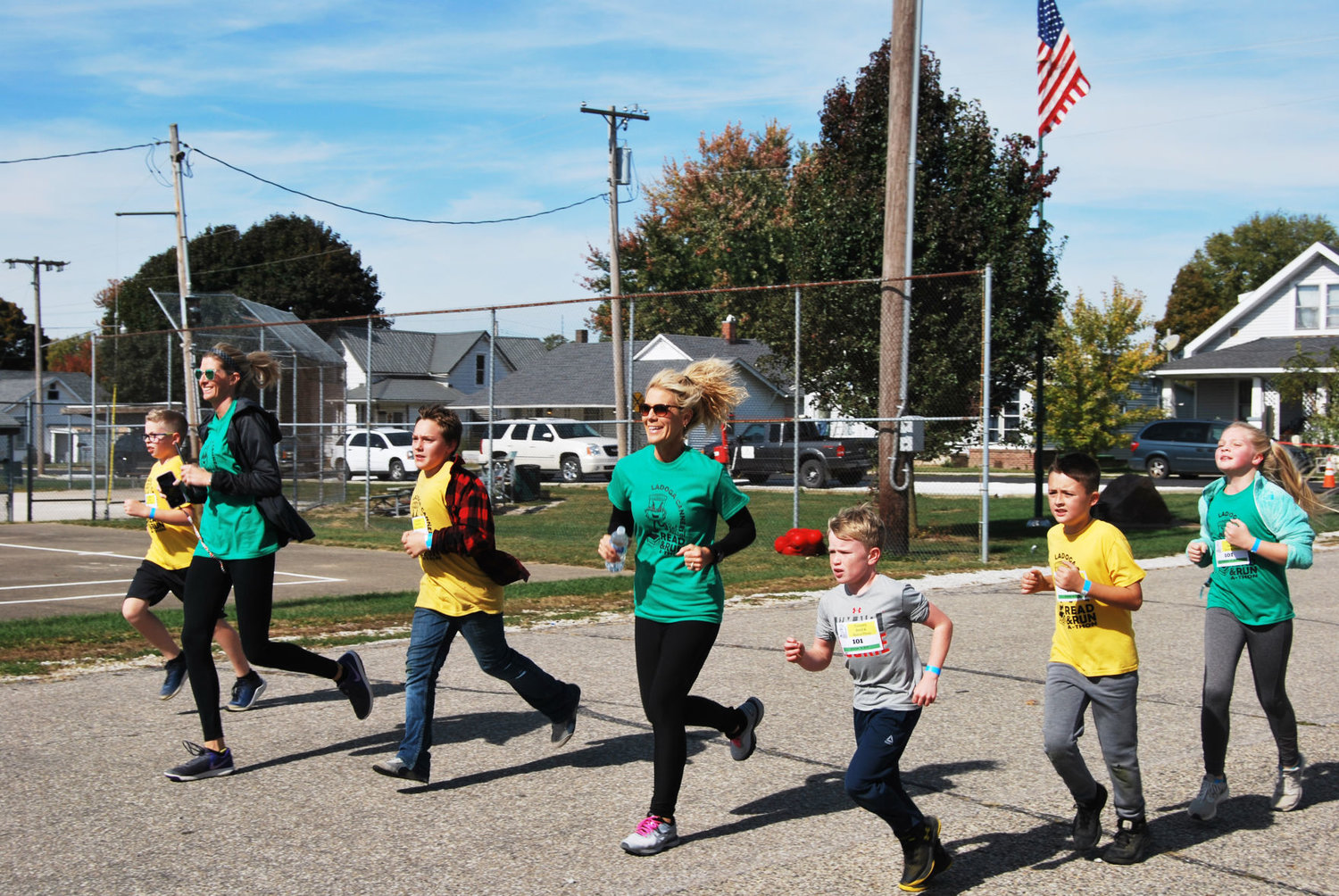 Teachers, Kylene Gott (on the left) and Tammy McGaughey (on the right) run along side with their students