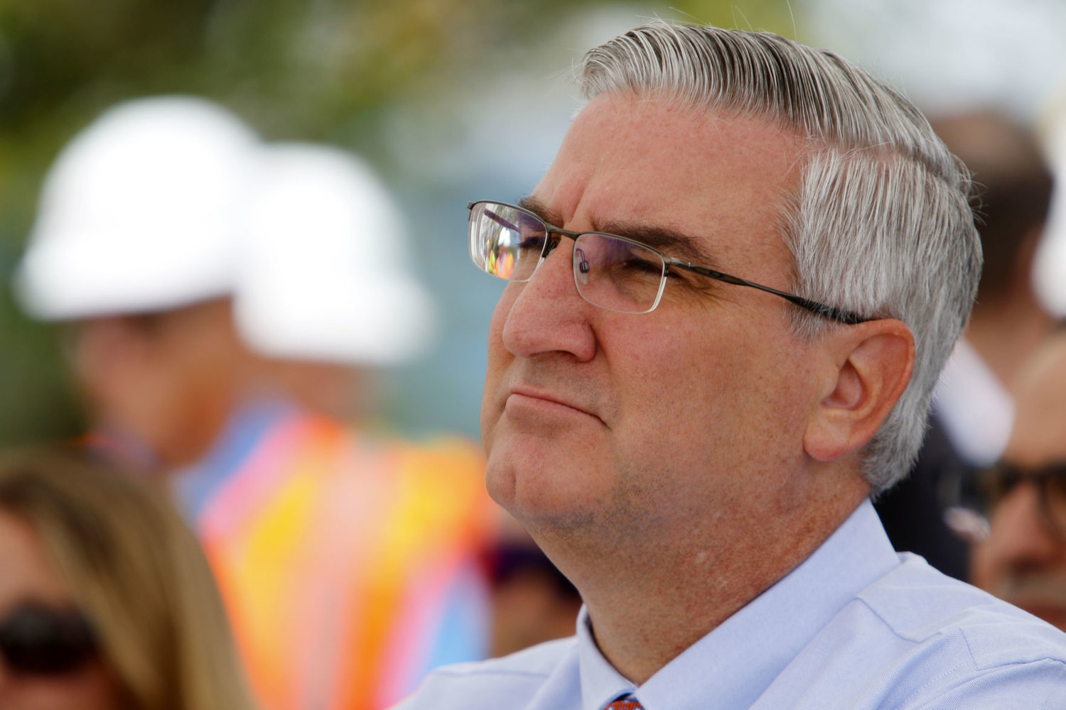 Indiana Gov. Eric Holcomb listens as town and construction officials brief him on the Calumet Avenue and 45th Street realignment project Aug. 30, 2019, in Munster.