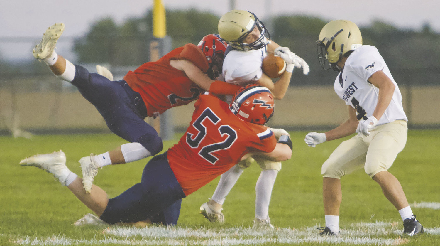 North Montgomery's Kai Warren and Drew Webster topple a Tri-West ball carrier.
