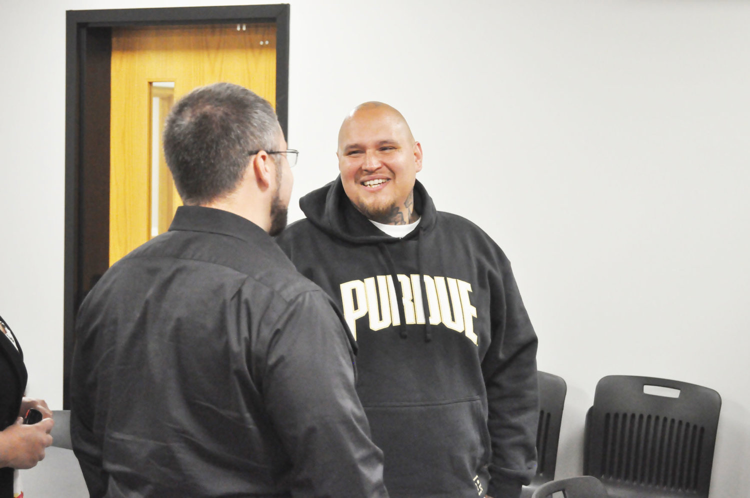 Josh Sanchez, right, speaks with Jared Walker of Through the Gate Tuesday at the Montgomery County Drug Free Coalition Red Ribbon Breakfast. Sanchez is a graduate of the Jail Chemical Addiction Program.