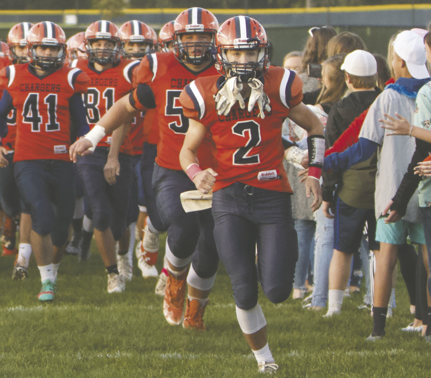 North Montgomery senior Kai Warren leads the Chargers onto the field during a home game this fall.