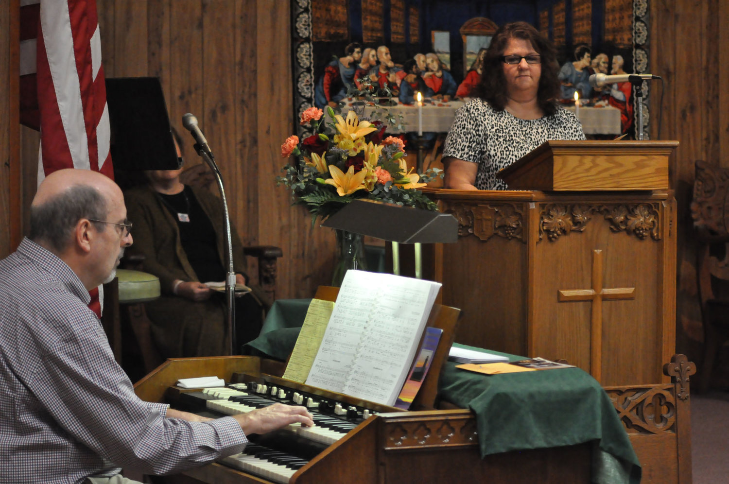 Kathy Addler listens as her husband, Ron, plays the organ Sunday during the final worship service at Milligan Memorial Presbyterian Church. The land for the building was donated in the 1890s by Gen. Lew and Susan Wallace.