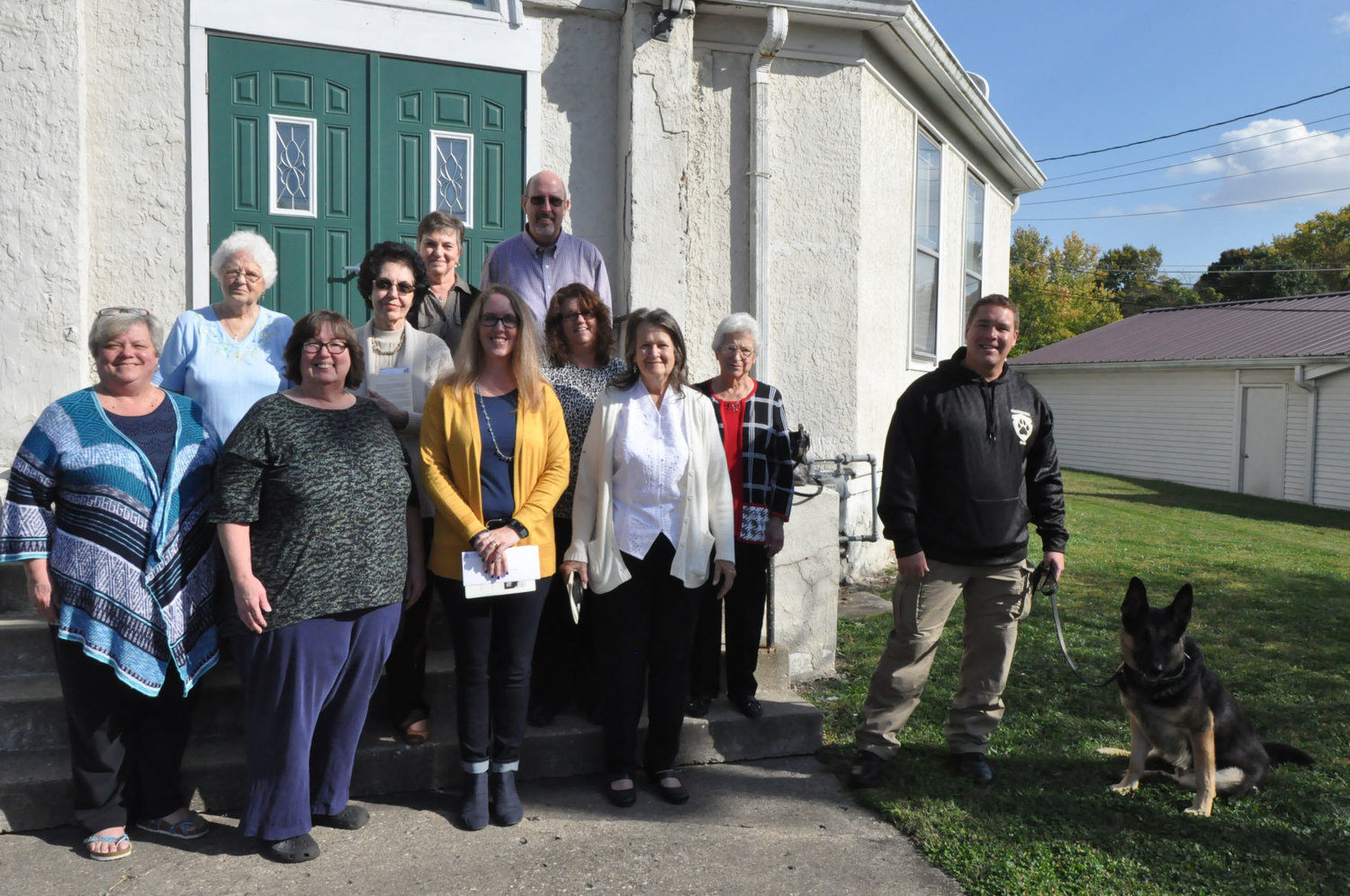 Recipients of funds from Milligan Memorial Presbyterian Church pose for a photo with church members Sunday after the final service. The church donated money to five groups.