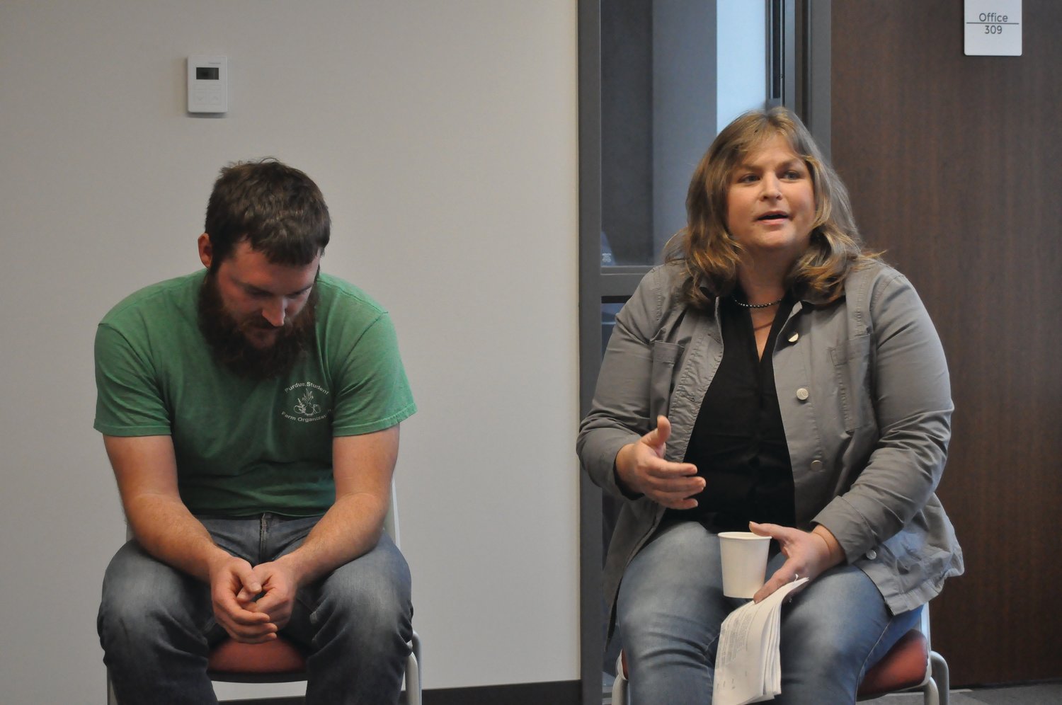 Jessica Roosa, right, president of This Old Farm, speaks during a panel discussion as Chris Adair of Purdue Student Farm listens Wednesday at the Montgomery County Local Food Summit in Fusion 54.