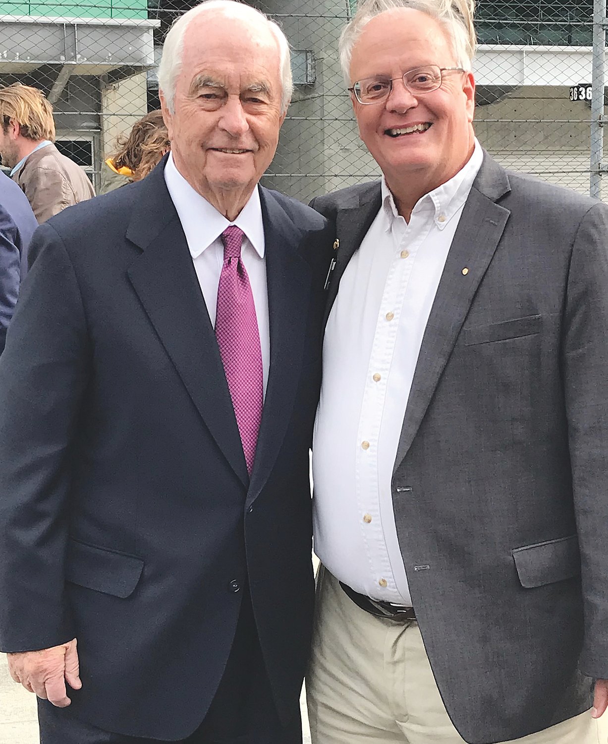 Penske Corporation Chairman and Founder Roger Penske and Indiana Racing Memorial Association Co-Chair and Co-Founder Mark Eutsler on Indianapolis Motor Speedway Pit Lane following the announcement that Penske Entertainment Corp. will acquire IMS, the INDYCAR Series, and IMS Productions from Hulman and Company. Eutsler is also a member of the Citizens