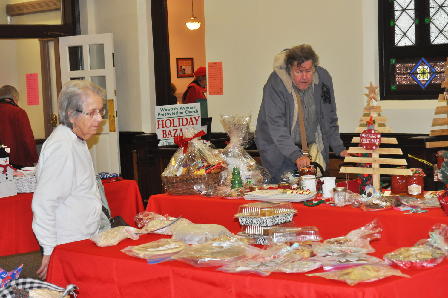 Shoppers look over the selection of cook- ies, pies and gift baskets on sale Thursday at the Wabash Avenue Presbyterian Church Holiday Bazaar. A bazaar en- core is planned for 9 a.m. to noon Saturday at the church.