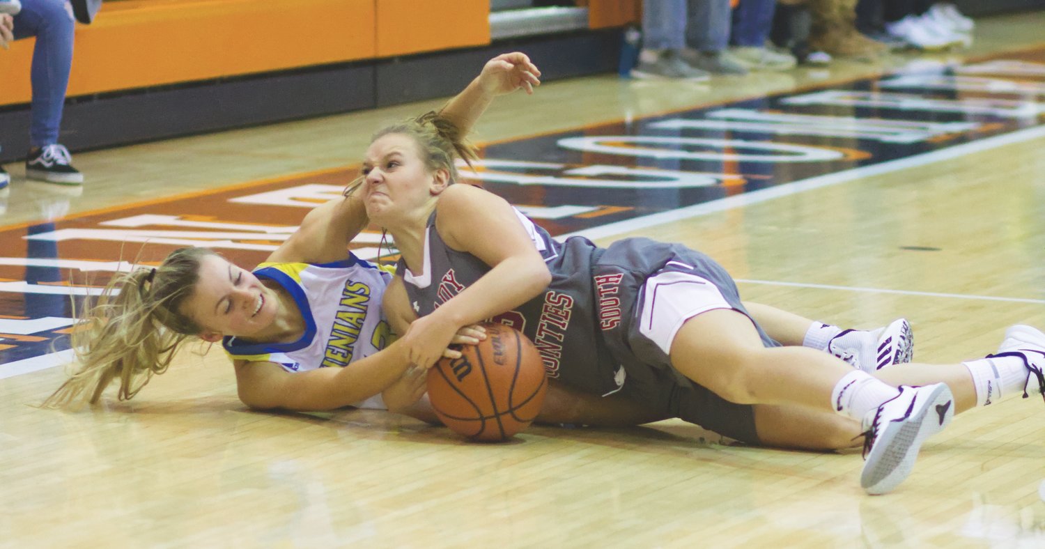 Southmont's Addi Charles and Crawfordsville's Lauren Kellerman battle for a loose ball. Kellerman led all scorers with 23 points, while Charles led the Mounties to a win with 11 points.