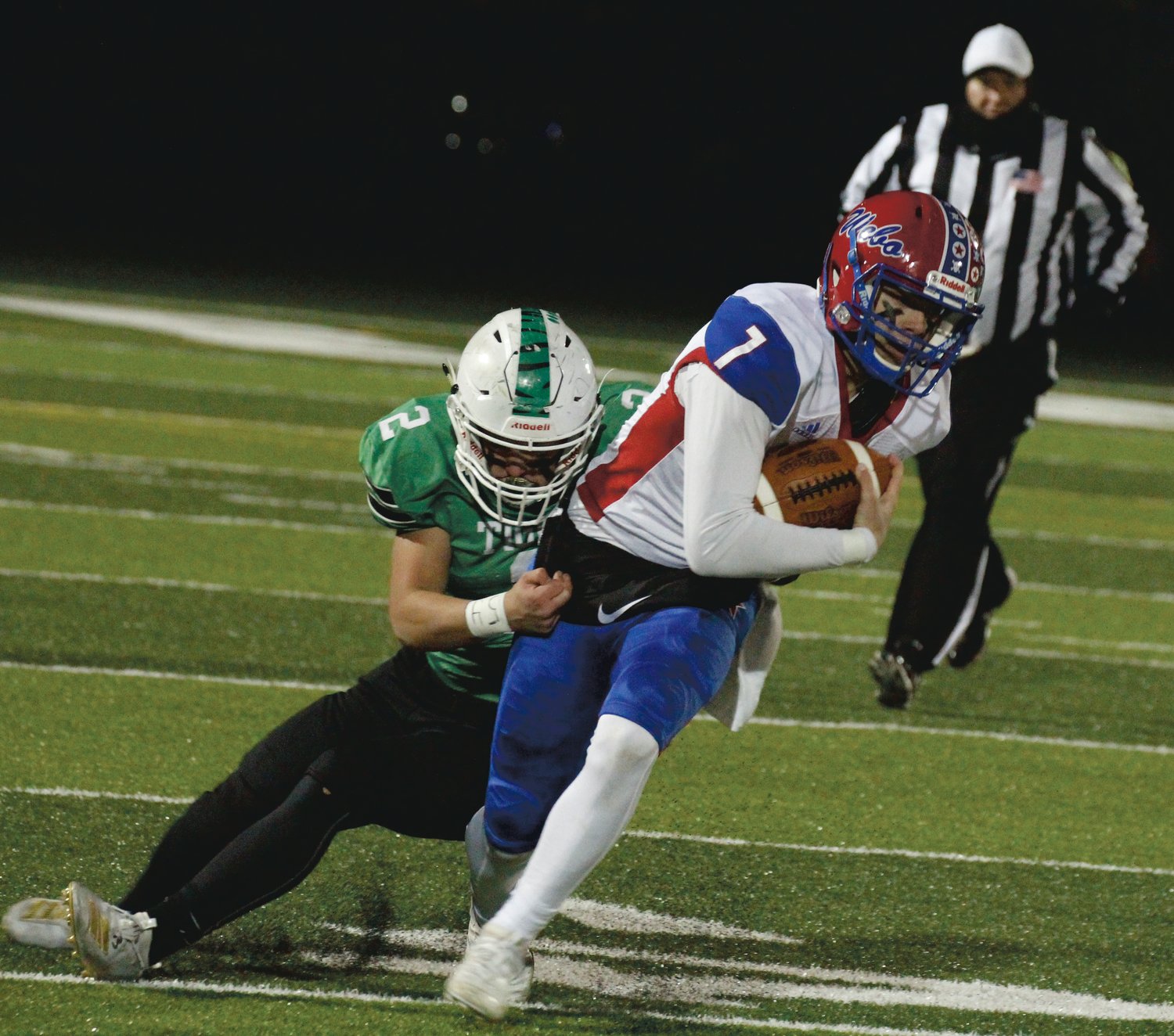 Western Boone quarterback Spencer Wright tries to break free from a tackle.
