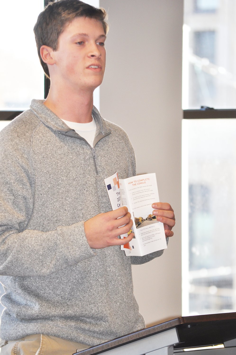 Wabash College student Brayden Lentz shows a brochure about the census Wednesday at Fusion 54. Students launched an online collection of materials to encourage local participation in next year's count.