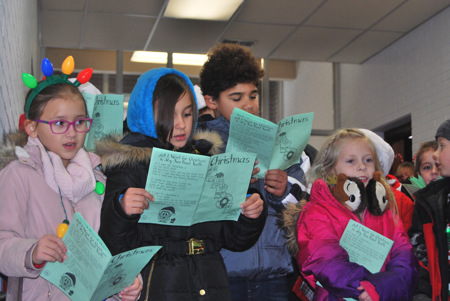 Nicholson Elementary School students sang Christmas songs Friday at local businesses, including the Journal Review. There were about ninety children from four classrooms who helped spread holiday cheer.