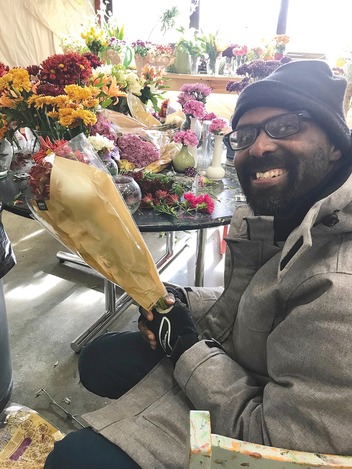 Carlton Hudgins, a client of Abilities Services Inc. of Crawfordsville, helps arrange flowers for delivery to local nursing homes. It is one of many community outreach programs ASI clients and staff participate in.