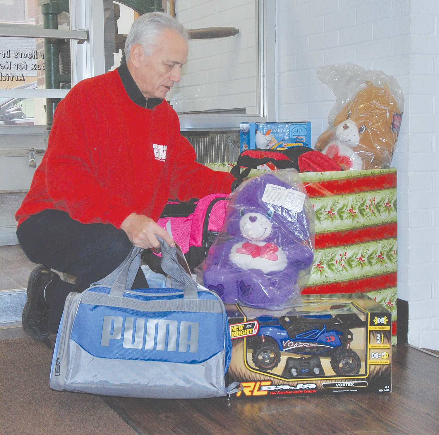S. David Long picks up items donated at the Journal Review as part of the 26th annual Opeartion Toybox toy drive. Each year the Indiana National Guard and members of Delta Theta Tau sorority organize the drive to ensure as many children as possible wake up to at least one new toy under the tree on Christmas morning.