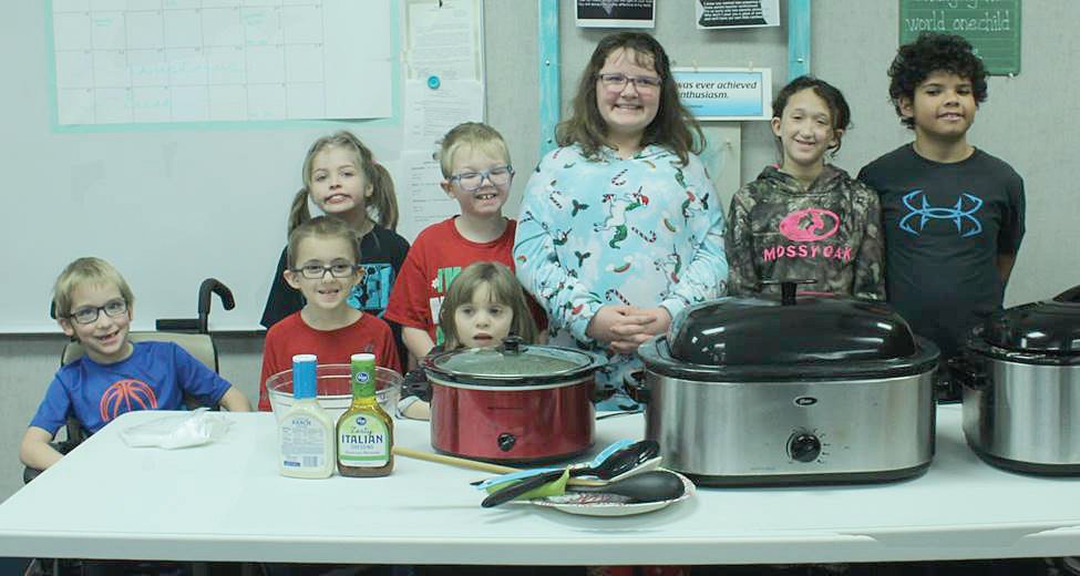 Students in Mrs. Maggie Sockwell’s class at Turkey Run Elementary prepared a luncheon for the staff members recently. The meal consisted of chicken and noodles, mashed potatoes, green beans, salad, rolls and cupcakes. The students have been learning how to measure, how to prepare and how to plan and cook a simple meal. Each student had a chance to help with the different steps of preparing the meal. The class also presented the staff members with a personalized holiday card. Preparing the meal was a way for the students to incorporate the skills that they’ve been learning with a hands-on activity. Helping the students with the meal preparation were Mellissa Giloogly, Heidi Secuskie, Lindsay Garner, Donna Brown and Helen Kiger. Students preparing the holiday luncheon were front row, Jason Dunavan, Caleb Myers and Emma Portier; and back row, Emma Mathas, Matthew Yockey, Makayla Canfield, Lacy Flak and Nate Reid. Not pictured are Cierra Lindley and Andrew Wilson.