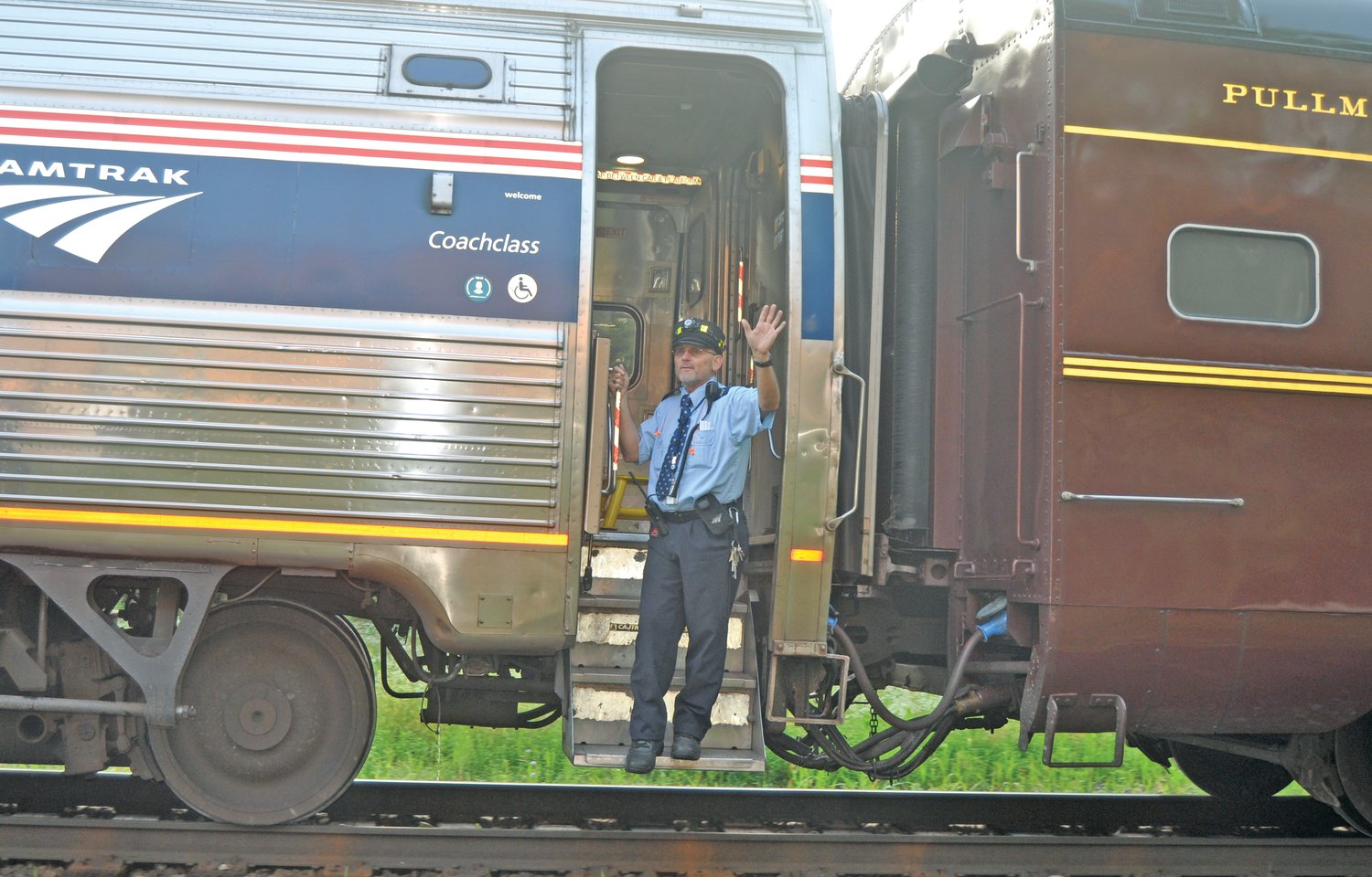 A conductor waves as Amtrak's Hoosier State pulls away from Crawfordsville on one of its final stops. The state has ended funding for the service.