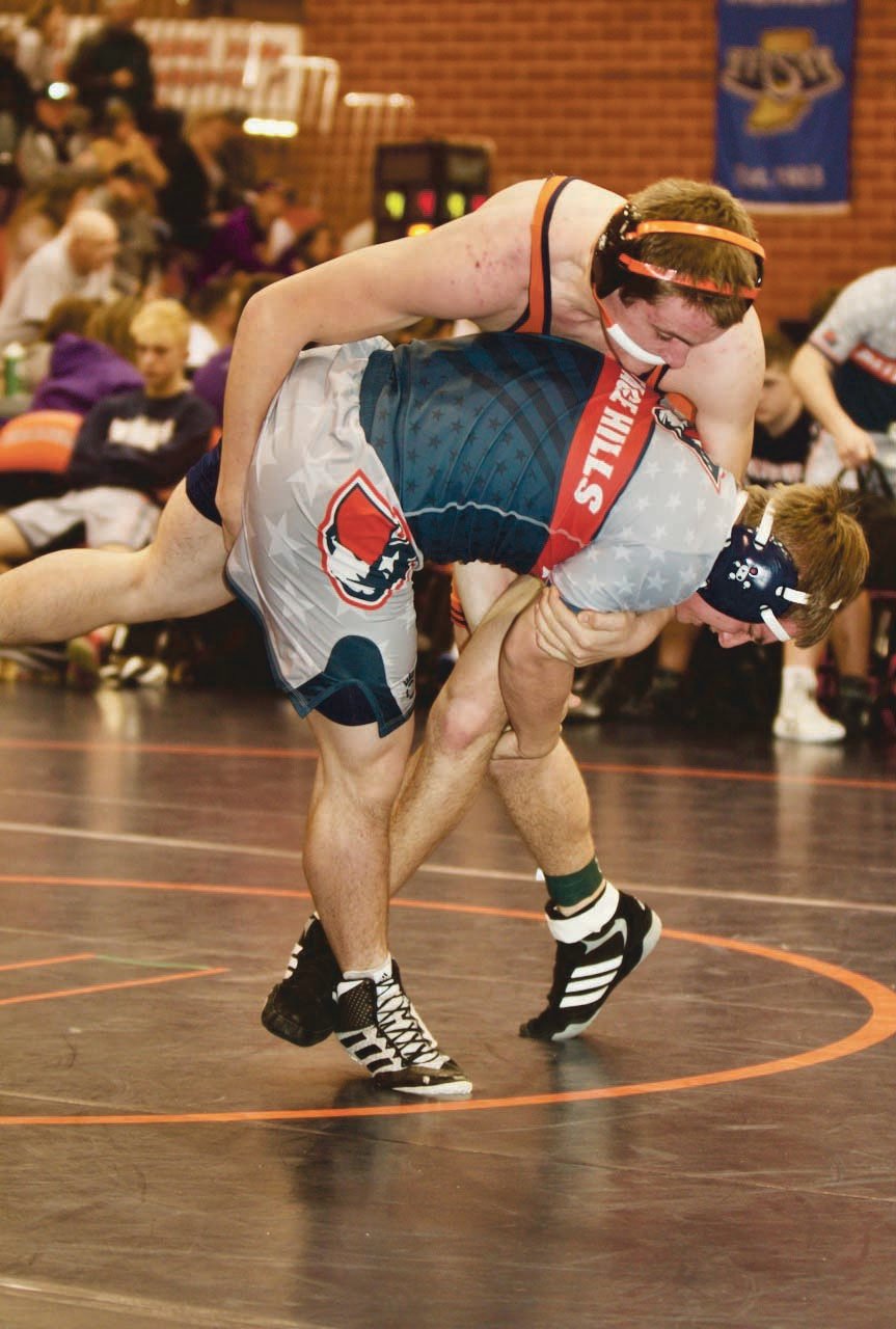 North Montgomery's Todd Laffoon looks for the takedown against his Heritage Hills opponent.