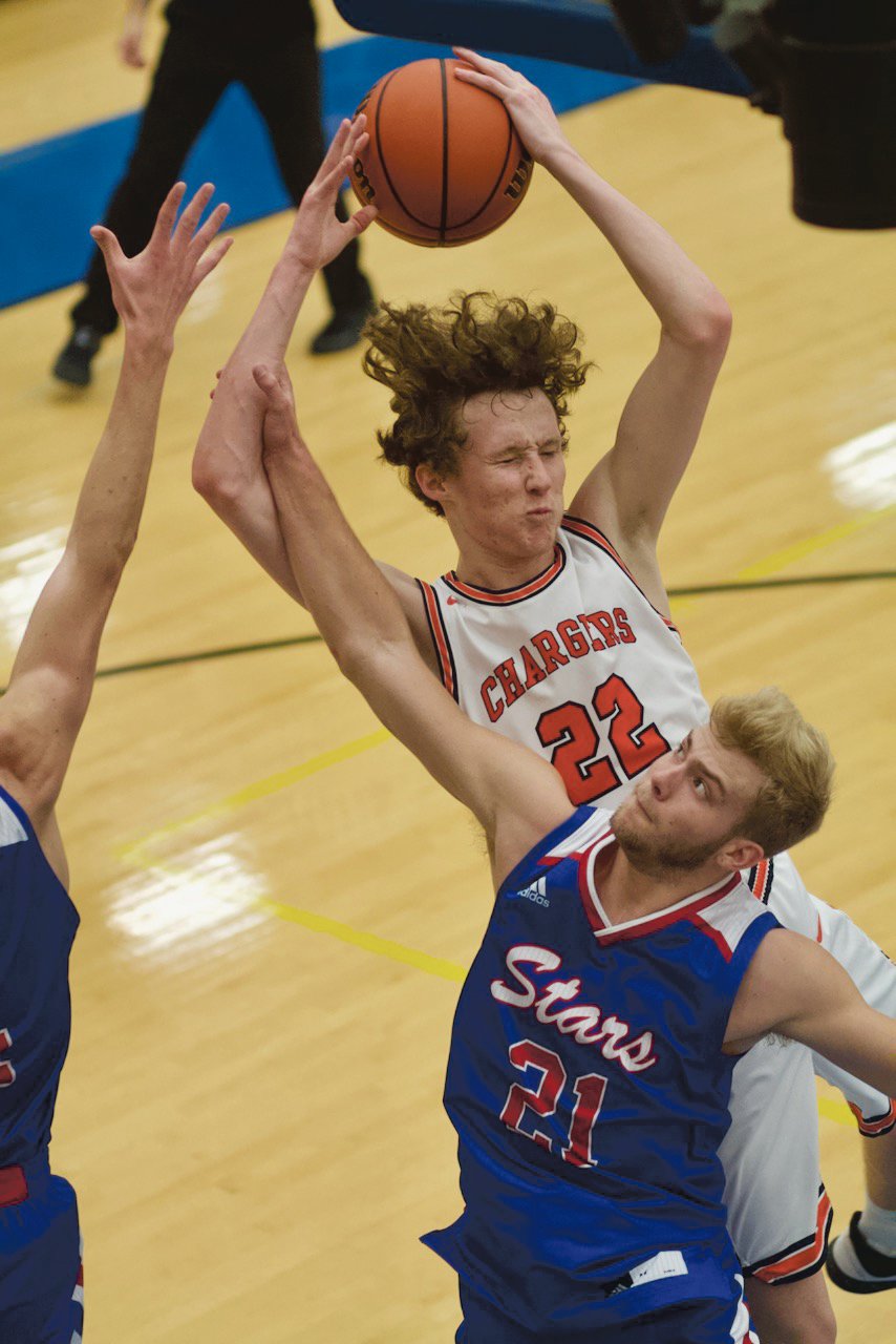 North Montgomery's Preston Shaw lskies over Western Boone's Spencer Wright for a rebound.