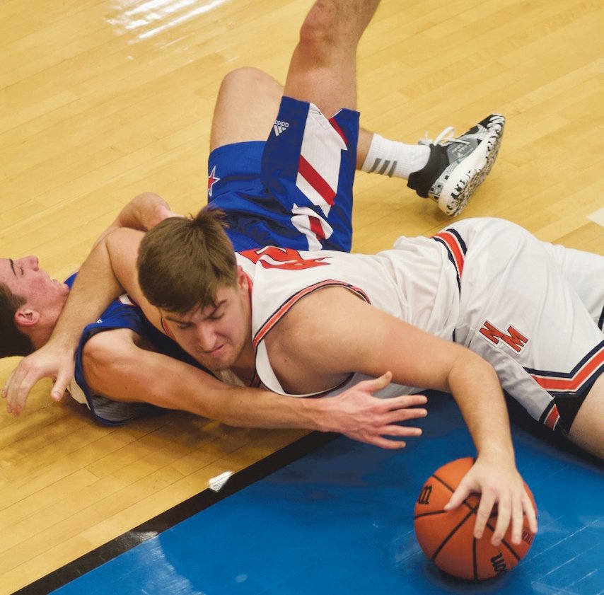 North Montgomery's Jack Thompson fights for a loose ball. The senior scored 10 points in the Chargers 50-49 loss to Western Boone.