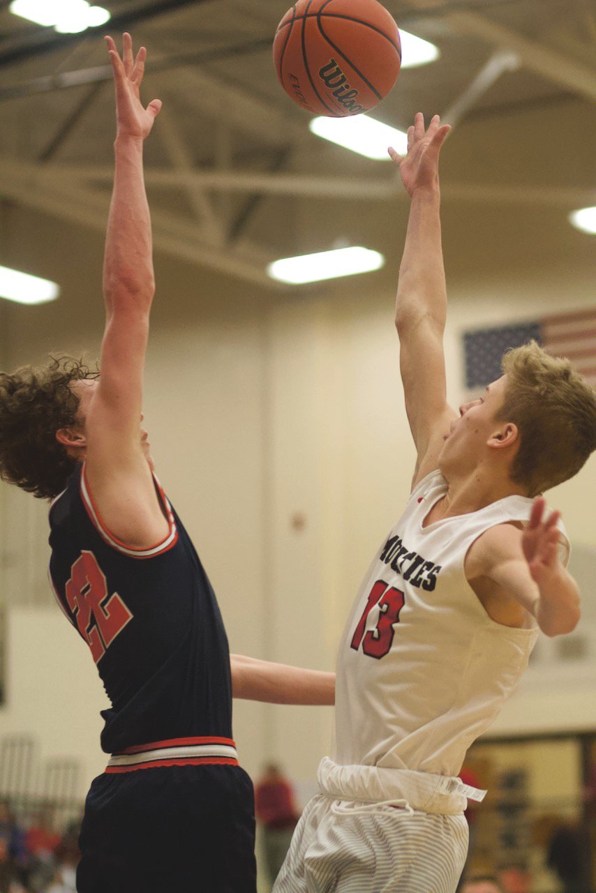North Montgomery's Preston Shaw attempts to block a shot of Southmont's Cale Hess in a Charger win last Saturday.