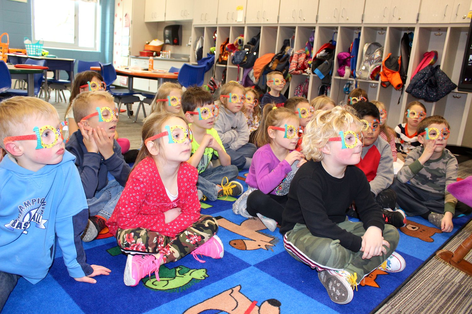 Kindergarten students at Sommer Elementary listen to a story Friday while donning their "100" glasses to celebrate their 100th day at school.