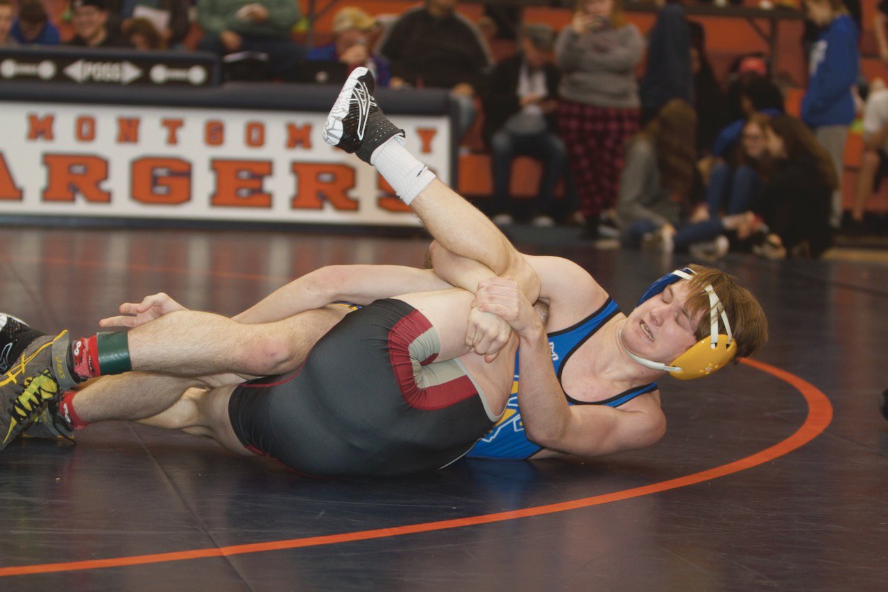 Crawfordsville's Alex Brown works on a pin against Danville's Nate Taylor.