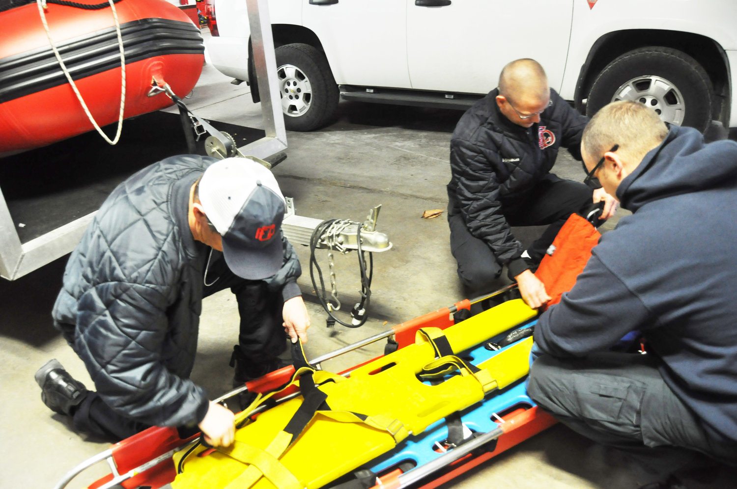 Crawfordsville firefighters, from left, Todd Fouty, James Manion and Jeremiah Thompson test a basket stretcher Tuesday at Crawfordsville Fire Station No. 1. The department has experienced a steady rise in emergency calls in recent years.