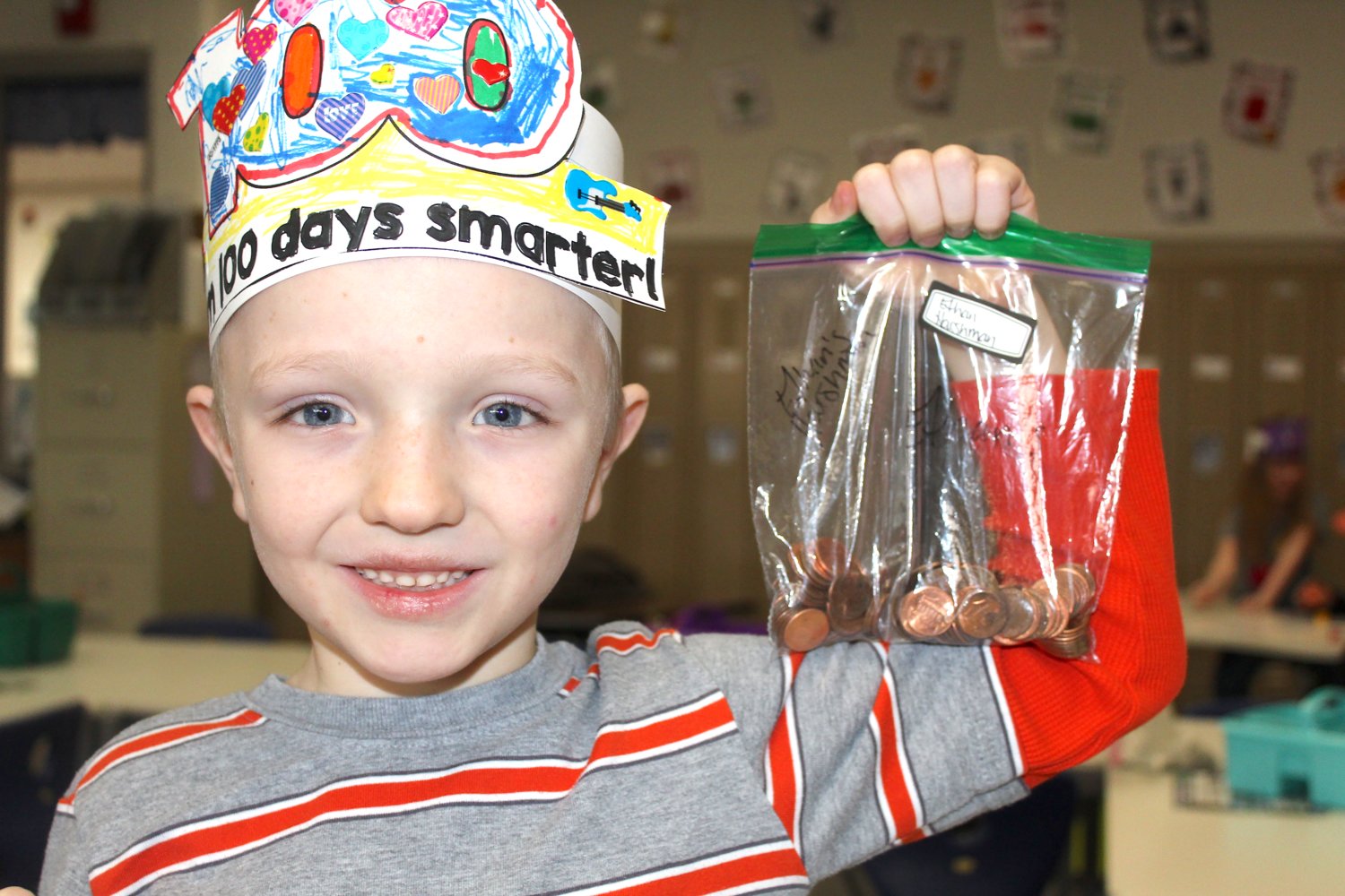 Hose first grader Ethan Harshman, 7, shows off a bag of 100 pennies he brought to school Wednesday in honor of his 100th day of the 2019-20 school year.