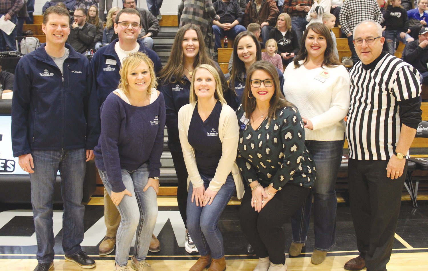 Photo Provided
Friday was Fountain Trust Company Night at the Parke Heritage High School boys basketball game vs. Covington. Between games, members of FTC were recognized for their contributions to many of Parke Heritage’s academic and athletic programs. These include the academic banquet to be held this spring, football team members traveling equipment bags, T-shirts for the dance team clinic, basketball 1,000 point leader board for the boys at the middle school and for the girls at the high school, and team chairs used by basketball players and at graduation. Since 2002, The Fountain Trust Company has sponsored the popcorn bags and napkins at academic and sporting events for the school corporation. On Friday, FTC sponsored 500 bags of free popcorn for those in attendance. NCP Schools appreciates all of the contributions made by FTC. Thank you to Fountain Trust Company president Lucas White and other FTC staff members, which include Heather Martin, Grant Dickey, Christiana Overpeck, Cassidy Helms, Kristine Poer, Kelsey Kellams, Stacy Felix and Doug Weisheit who were in attendance at the ball game. Pictured are, from left, front row, Heather Martin, Kristine Poer and Cassidy Helms; and back row, Lucas White, Grant Dickey, Christiana Overpeck, Kelsey Kellams, Stacy Felix and Doug Weisheit.