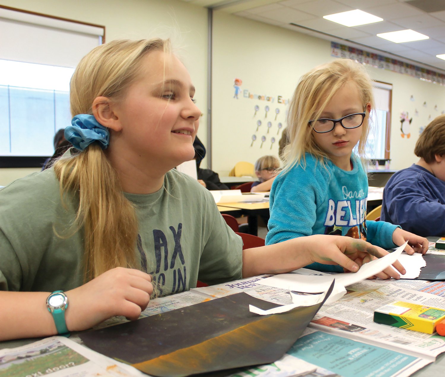 Claire and Annie Dennison, left, look to Art for Beginners instructor Linda Brady for the next step in creating their versions of the Aurora Borealis at the Crawfordsville Public Library on Saturday.