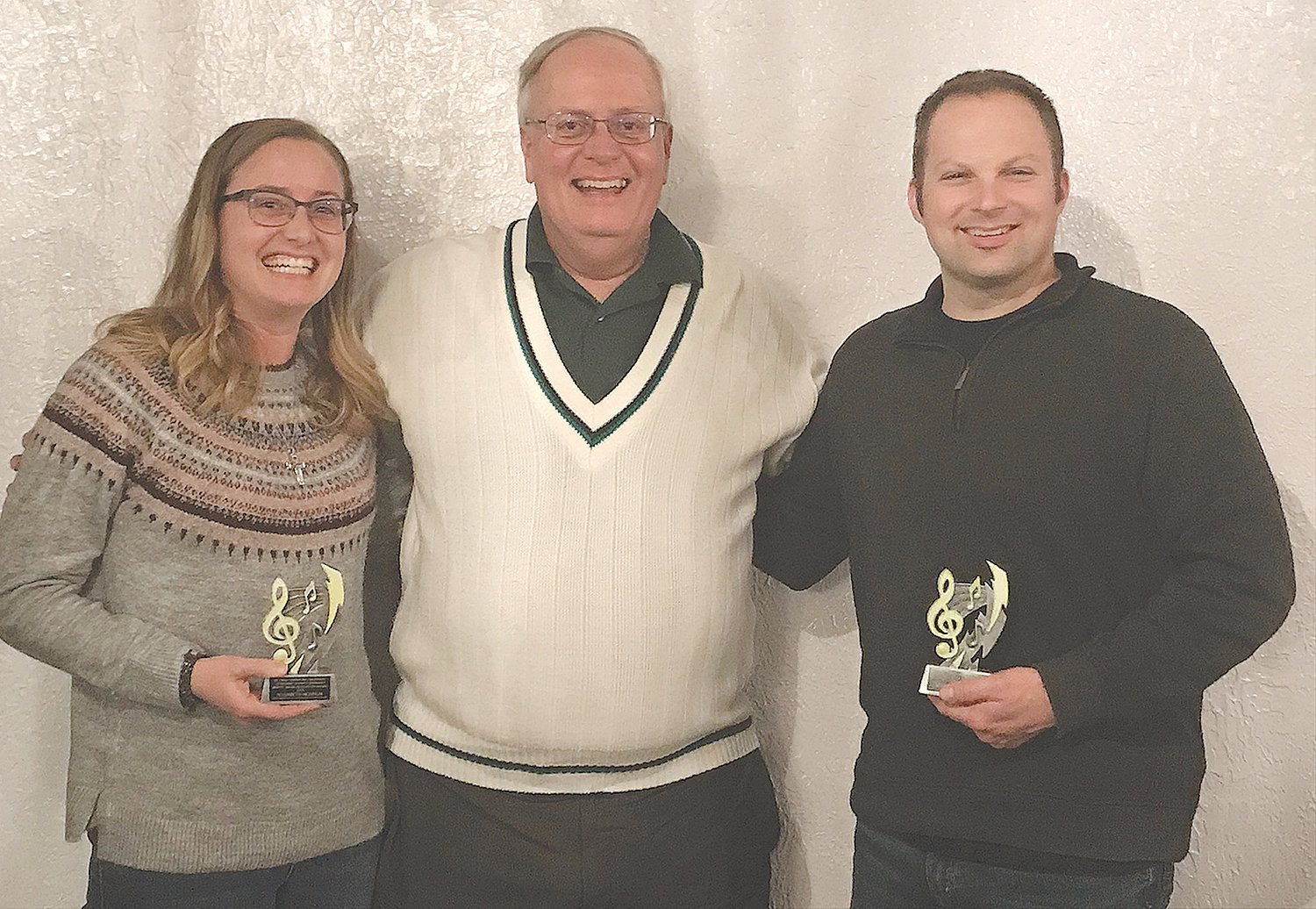 Elizabeth Newnum, left, and Andrew Simpkins, right, pose with Mark Eutsler after being honored with the 2019 Moffit Music Education Award.