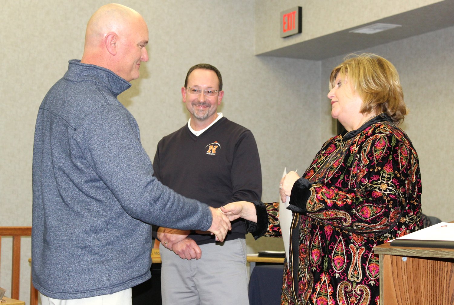 North Montgomery Athletic Director Matt Merica, left, receives the Heartsaver Hero Award during North's January public session. Presenting the award on behalf of the American Heart Association are Superintendent Dr. Colleen Moran, right, and school board President Gary Bohlander.