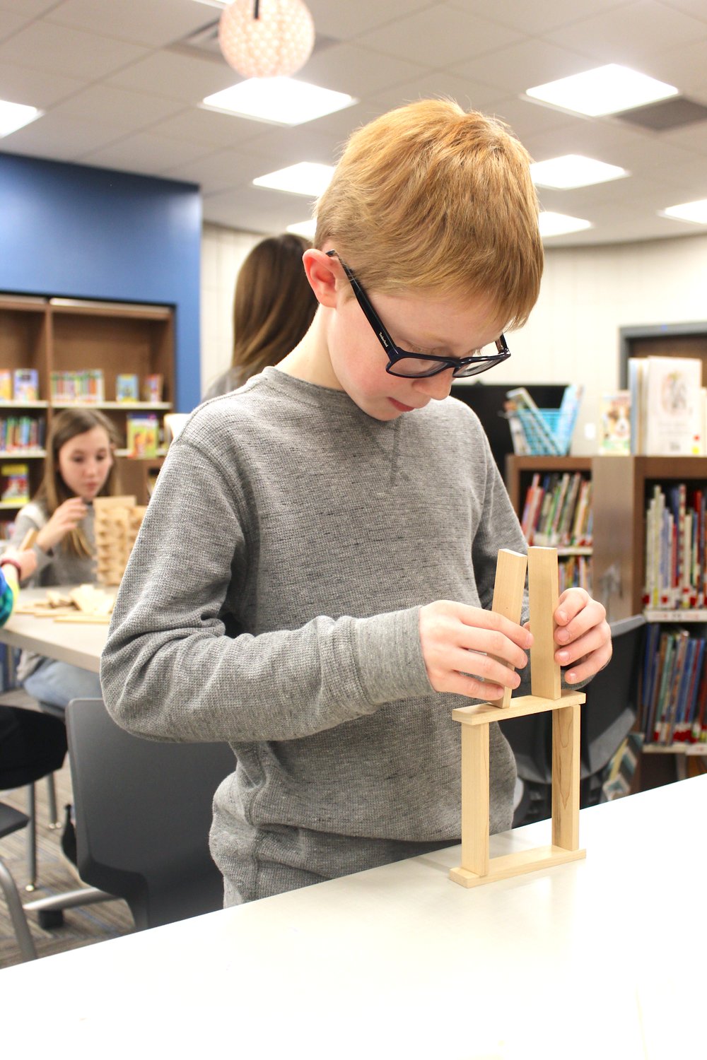 Fifth-grade Pleasant Hill student Boston Addler, 10, begins laying the foundation of a tower using Keva kits Thursday.