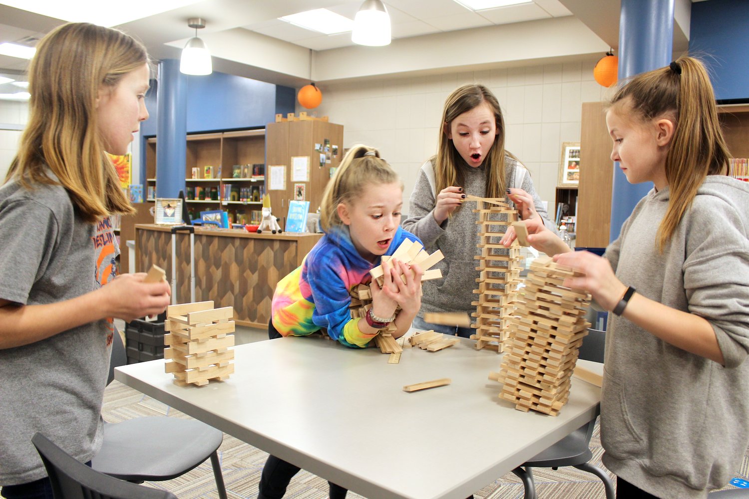 Pleasant Hill fifth graders Paige Yarger, from left, Gracie Ratcliff, Hannah Barnes and Bailey Grote, all age 11, learn why space is a valuable commodity Thursday in the school's media center while building towers with Keva plank sets.