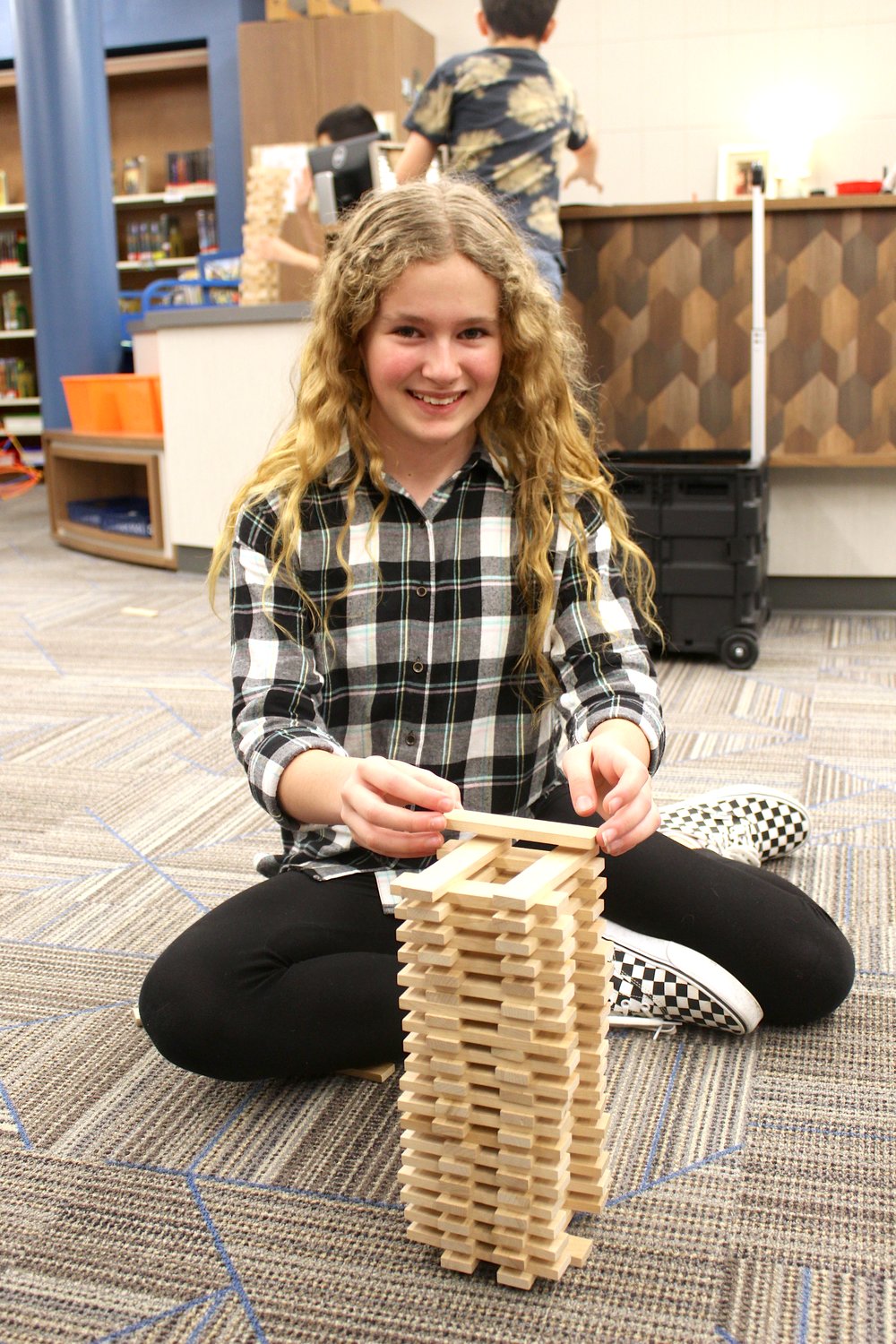 Courtney Ratliff, 10, shows off her Keva tower Thursday at Pleasant Hill.