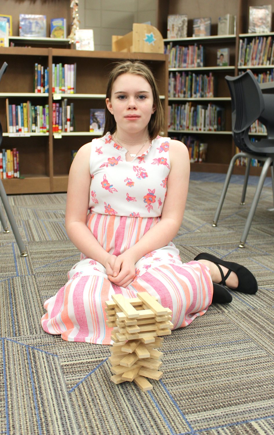 Leslie Cunningham, 10, begins her Keva plank tower with a spiral foundation Thursday at Pleasant Hill.