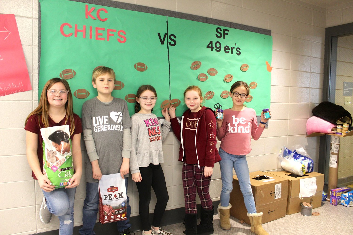 Fourth graders Sophie Welshimer, from left, Sam Rogers, Marlee Reed, Scarlett Bryant and Kenda McClamroch show off their fundraising talents Wednesday; Pleasant Hill students and teachers are collecting food, litter and cleaning supplies for the Animal Welfare League, proving there are many ways to be nice during International Kindness Week (Jan. 27-31).