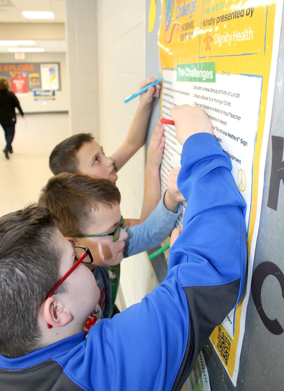 Pleasant Hill fourth-grade students Robert Hoffman, from above, Ben Oppy and Wyatt Harshbarger check off items on a list for The Great Kindness Challenge, a national initiative created by Kids For Peace to promote generosity and goodwill around the world; items seen on the list include smiling at 25 people, slipping a nice note into a friend's backpack and entertaining someone with a happy dance.